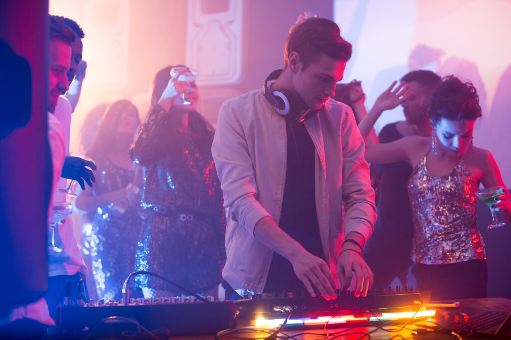 Young DJ Playing in Nightclub