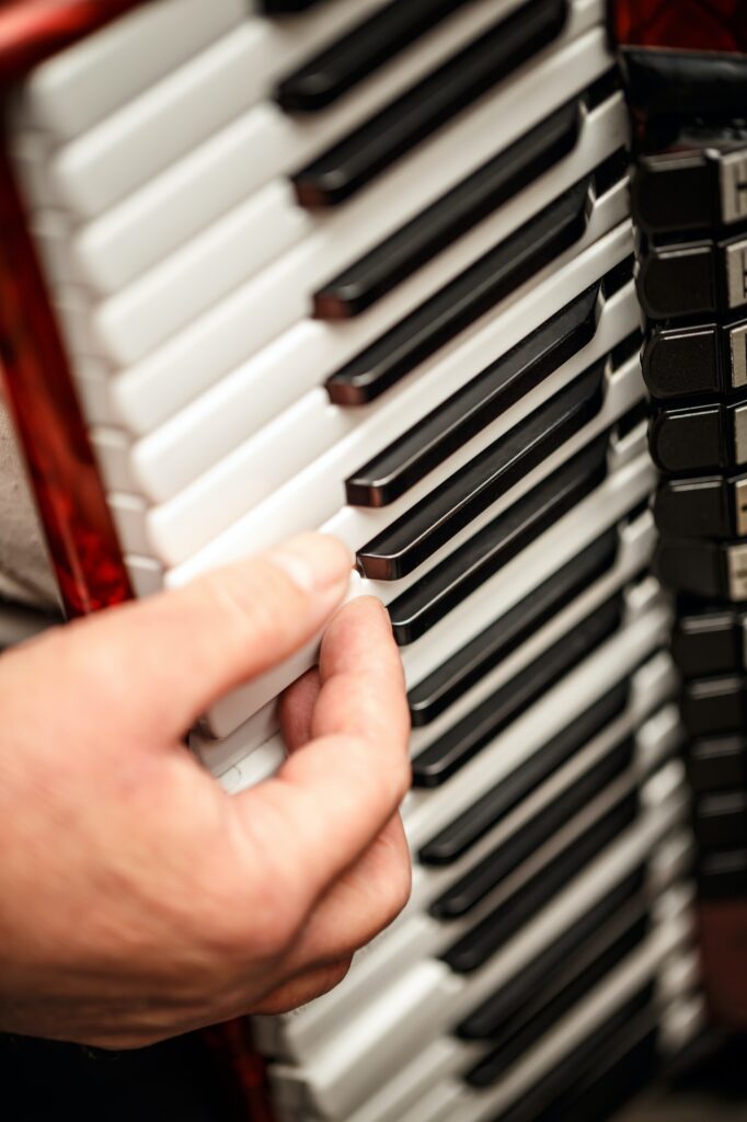 Hands playing an accordion instrument